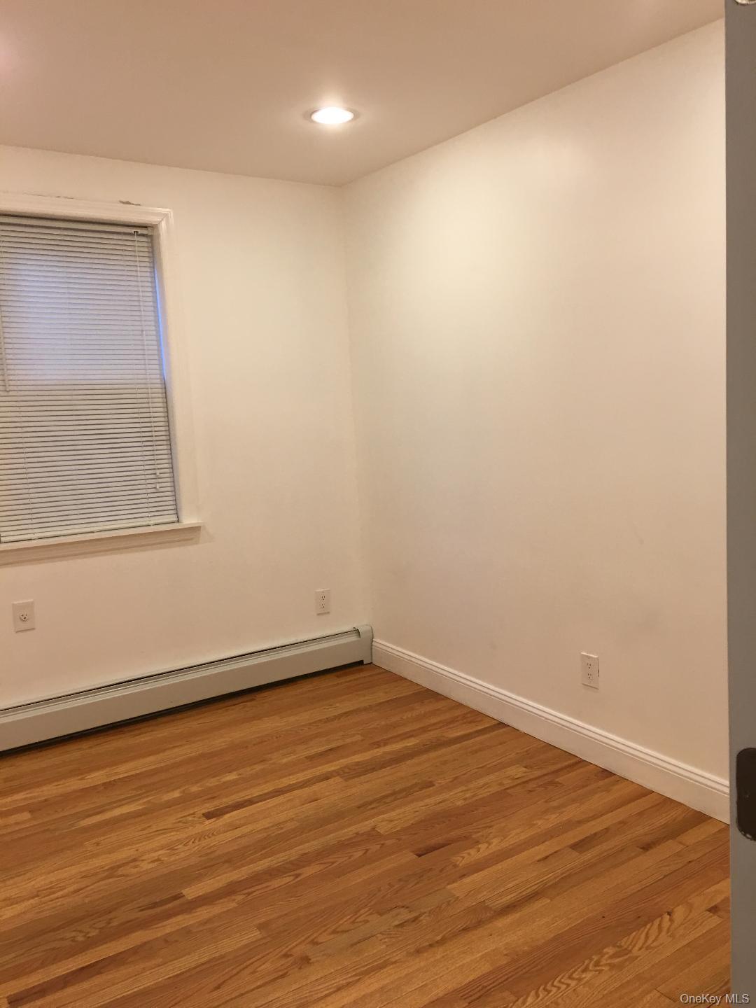 58 Main Street, Unit 1 Hastings-on-Hudson, NY 10706 - Photo 6 of 6 an empty room with wooden floor and windows