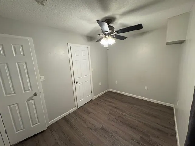 a view of a room with wooden floor and staircase