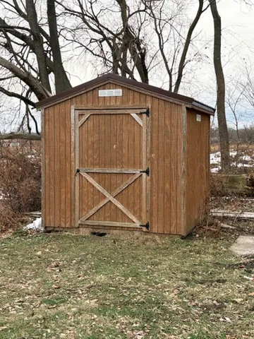 a view of a room with wooden floor and windows