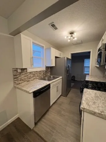 a kitchen with a sink stove and microwave