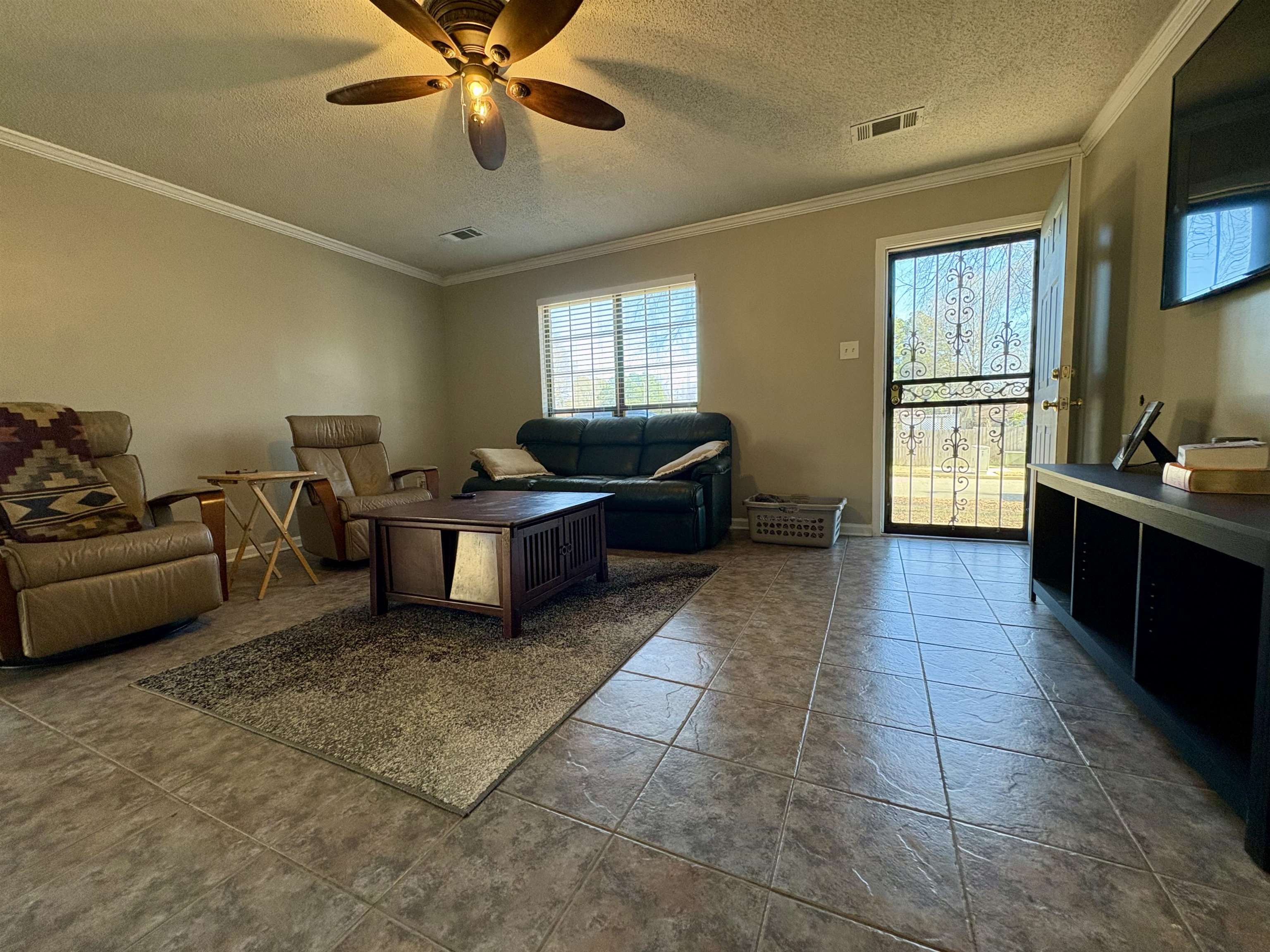 3507 Chowning Road Memphis, TN 38135 - Photo 4 of 17 Living room featuring ornamental molding, a textured ceiling, and ceiling fan