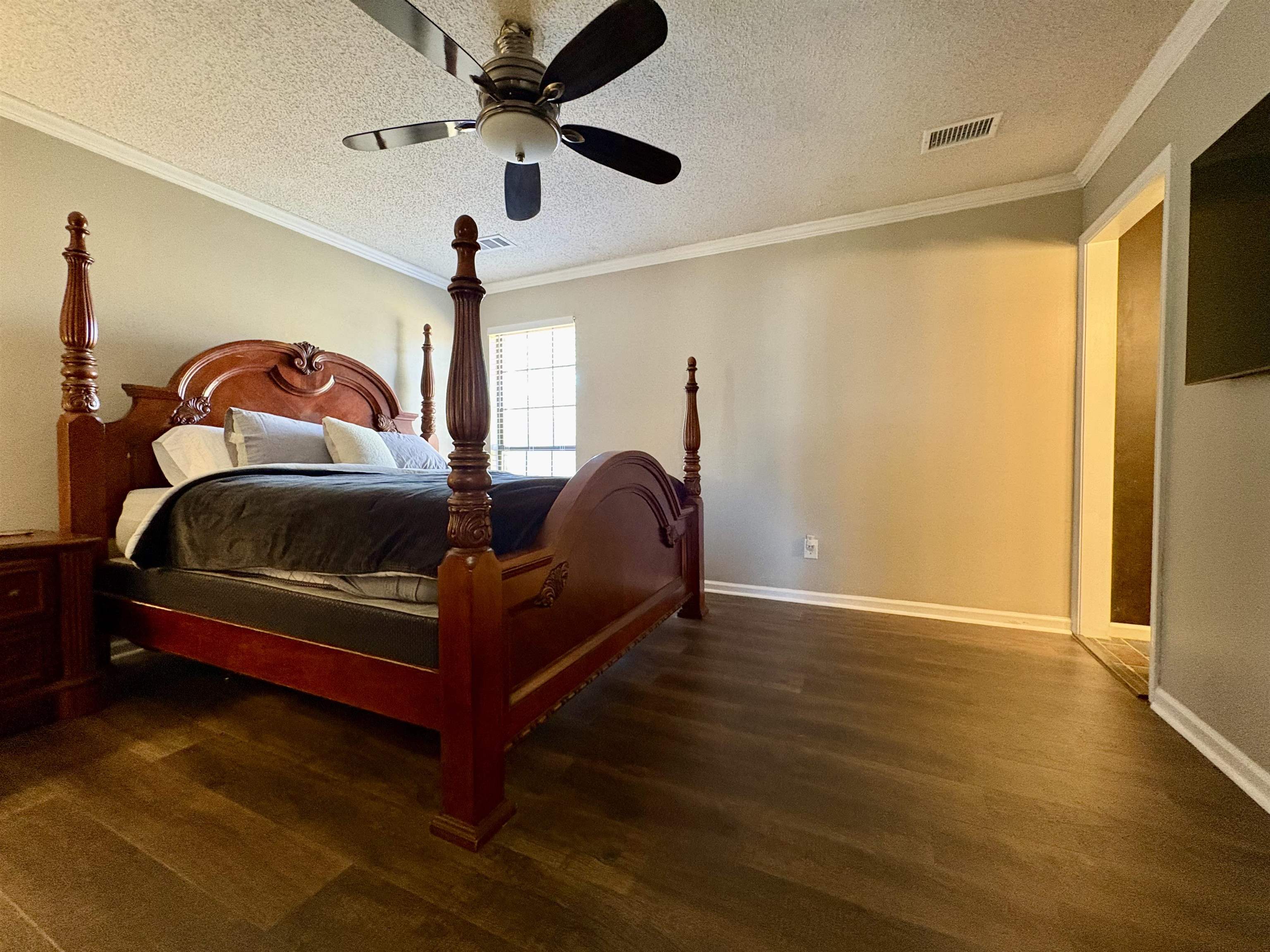 3507 Chowning Road Memphis, TN 38135 - Photo 7 of 17 Bedroom featuring a textured ceiling, ornamental molding, dark wood-style flooring, and a ceiling fan