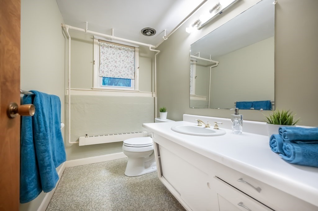 68 High Plain Road Andover, MA 01810 - Photo 29 of 33 a bathroom with a granite countertop sink mirror vanity and toilet