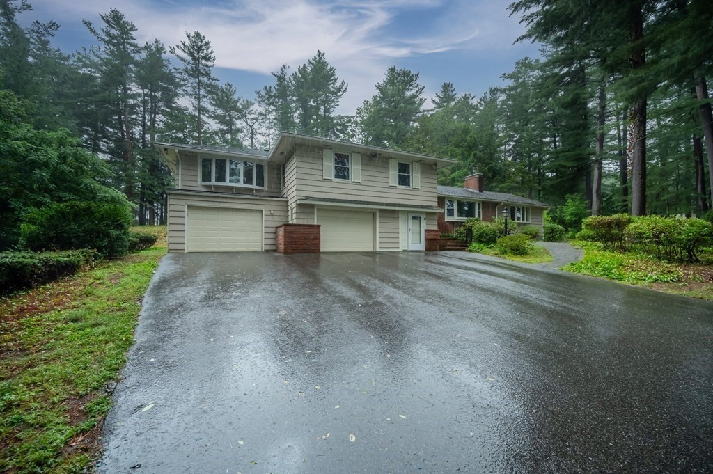 68 High Plain Road Andover, MA 01810 - Photo 33 of 33 a front view of a house with a garden and trees