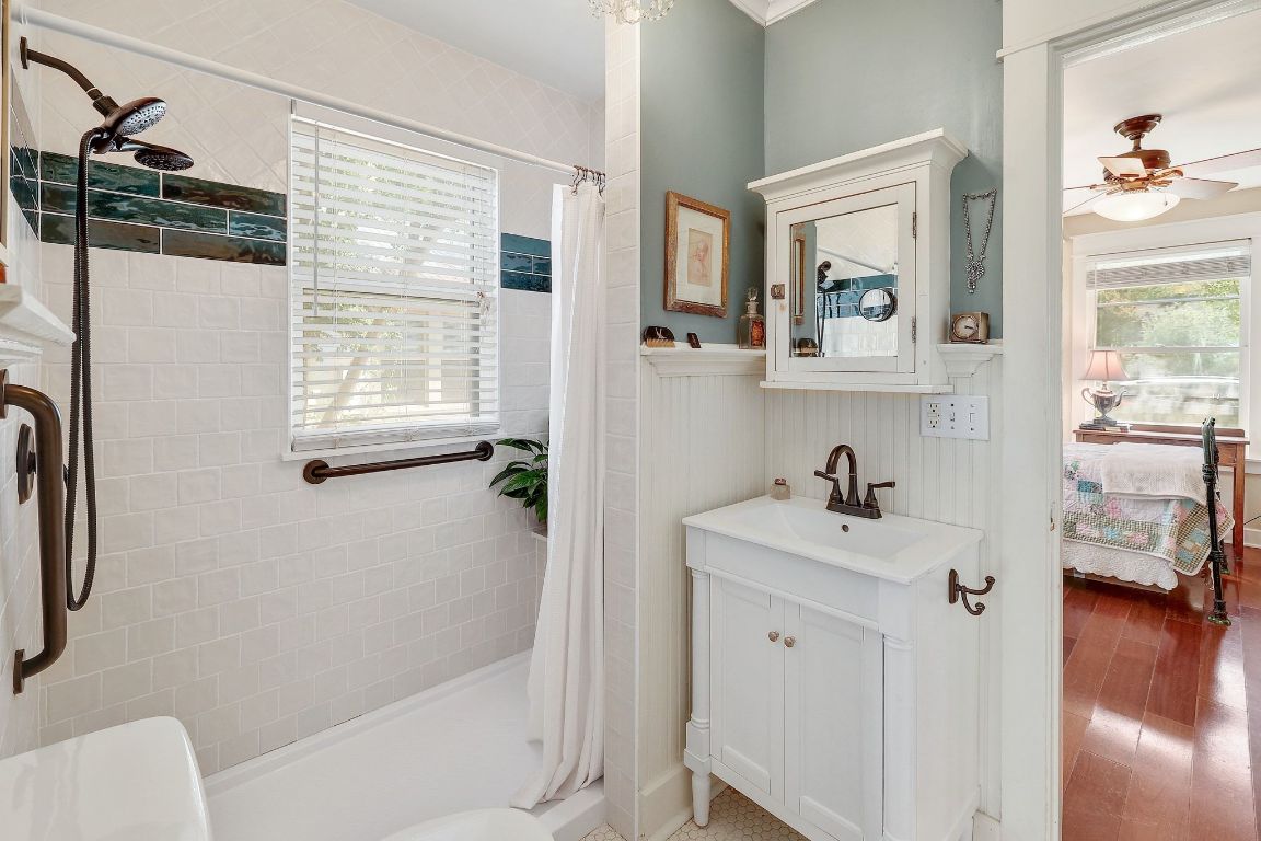 1006 East 44th Street Austin, TX 78751 - Photo 11 of 28 a bathroom with a sink a toilet and shower