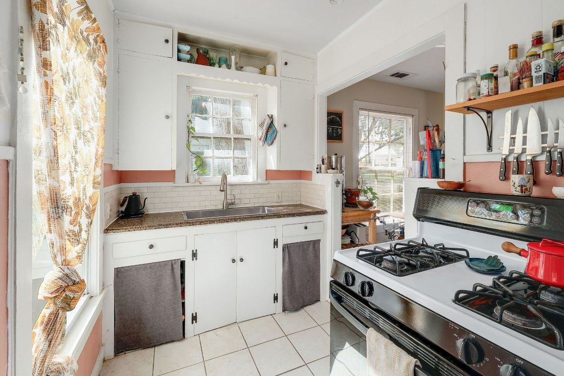 1006 East 44th Street Austin, TX 78751 - Photo 23 of 28 a kitchen with a stove a sink and a window