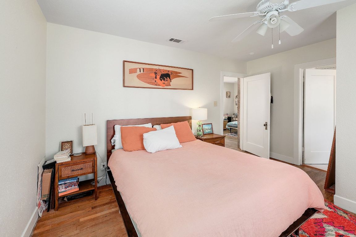 1006 East 44th Street Austin, TX 78751 - Photo 25 of 28 a bed room with a bed and a chandelier