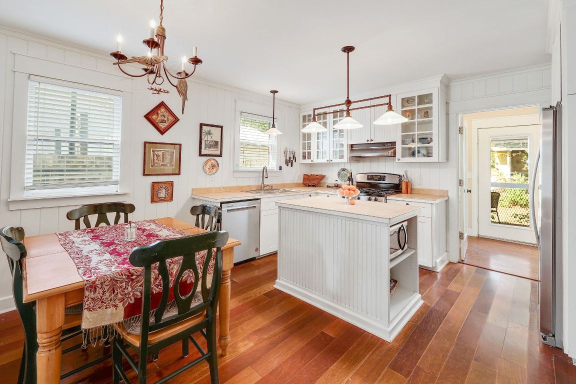 1006 East 44th Street Austin, TX 78751 - Photo 6 of 28 a kitchen with a stove cabinets and wooden floor