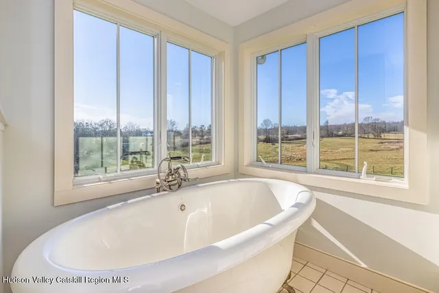 a bath tub sitting in a bathroom next to a window