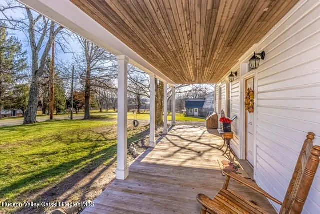 a view of a porch with wooden floor