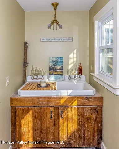 a kitchen with a stove a sink and a window