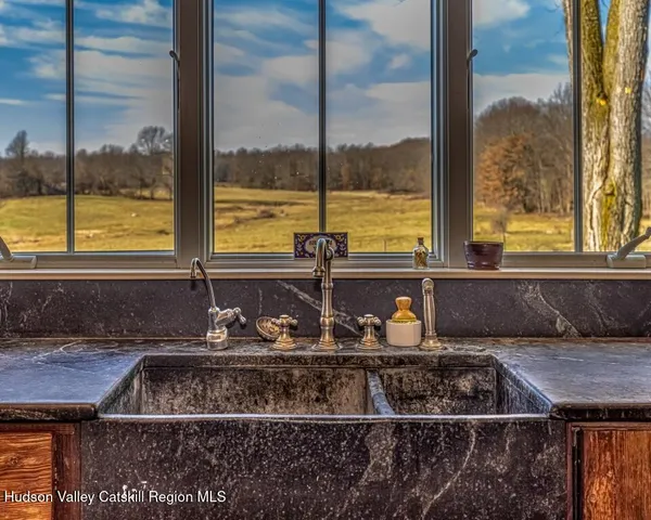a kitchen with a sink a counter and a chair