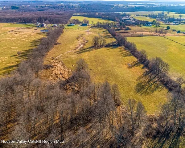 a swimming pool with lawn chairs and wooden fence