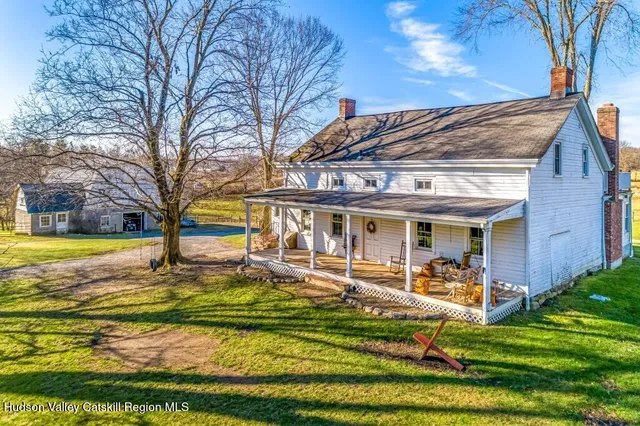 a view of a house with swimming pool and sitting area
