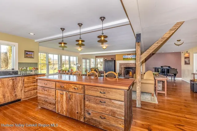 a view of a kitchen and dining area with wooden floor