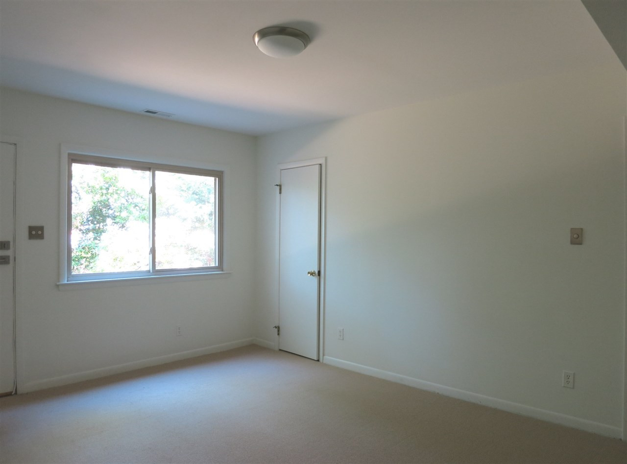 600 Davidson Street Raleigh, NC 27609 - Photo 21 of 25 Also on the Lower Level are 2 more spacious Bedrooms w/neutral carpet & lg closets; Laundry Rm w/neutral vinyl flr; updated Bath w/pedestal sink, marble tile flr & shower; and 1-car Garage w/storage closets. This is Bedroom 4. Bedroom