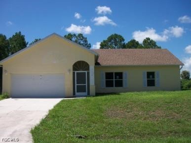 a front view of a house with yard and green space