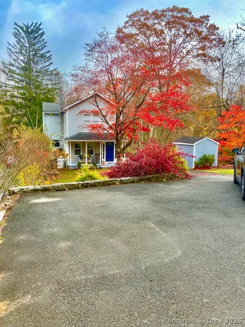 front view of house with a yard and potted plants