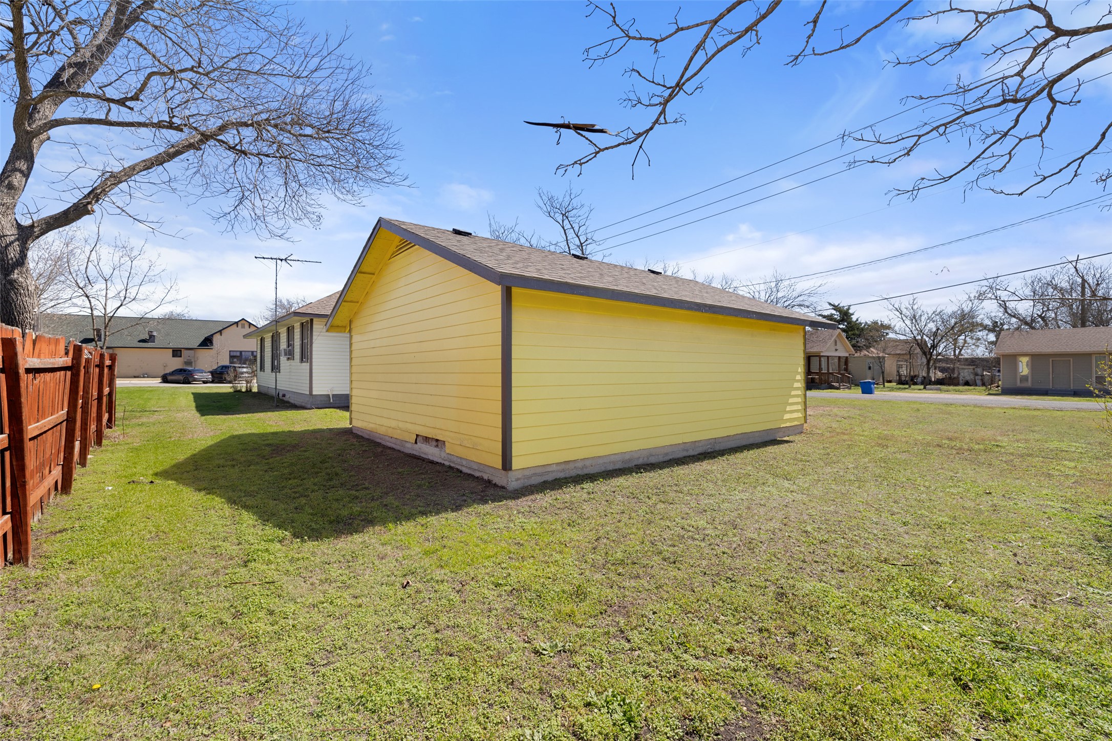 303 Vernon Street Taylor, TX 76574 - Photo 7 of 37 View of property exterior with fence and a lawn