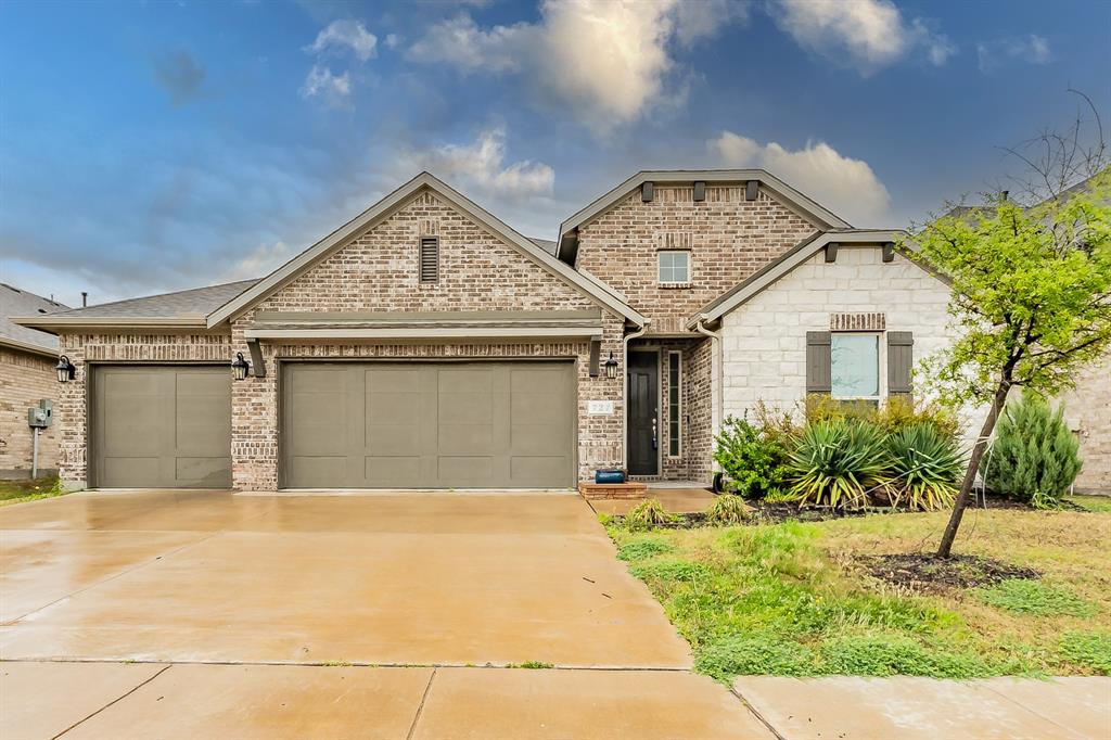 727 Mahogany Lane Forney, TX 75126 - Photo 1 of 1 French provincial home with an attached garage, brick siding, and driveway