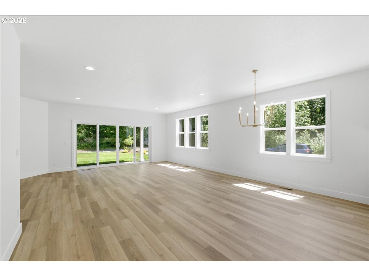 2147 Northeast Spitz Road Canby, OR 97013 - Photo 17 of 48 a view of an empty room with a window and wooden floor