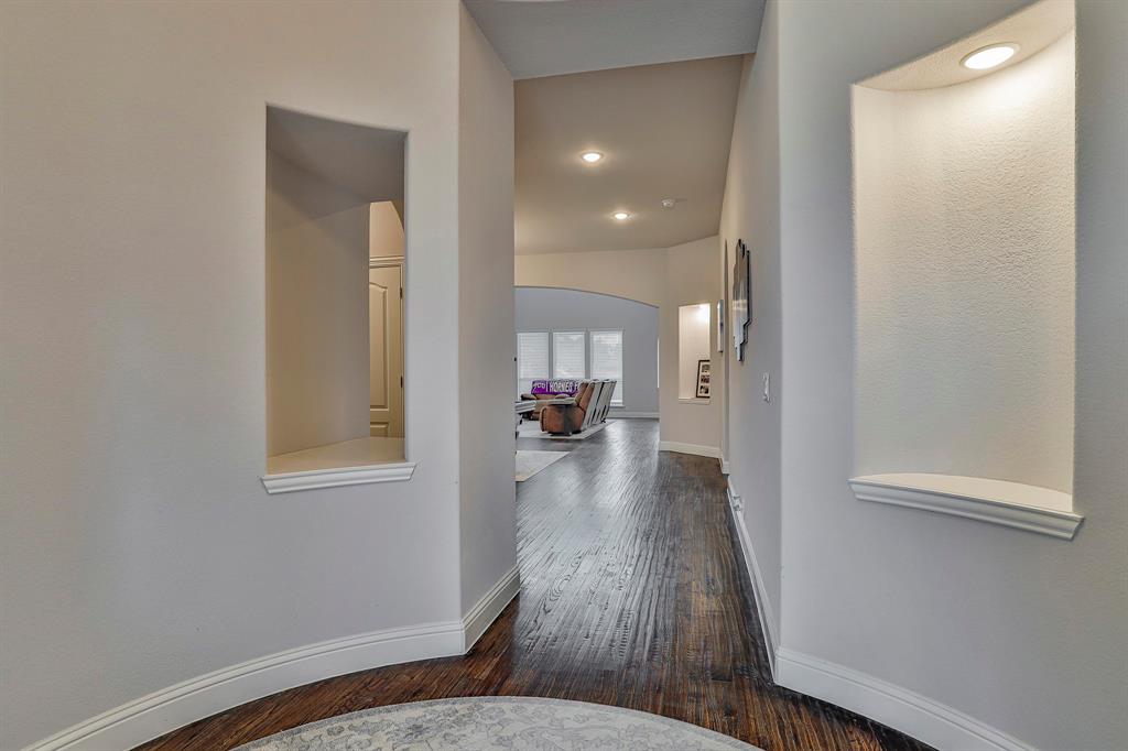 2425 Turning Leaf Lane Midlothian, TX 76065 - Photo 4 of 29 Corridor featuring arched walkways, dark wood-style flooring, and recessed lighting