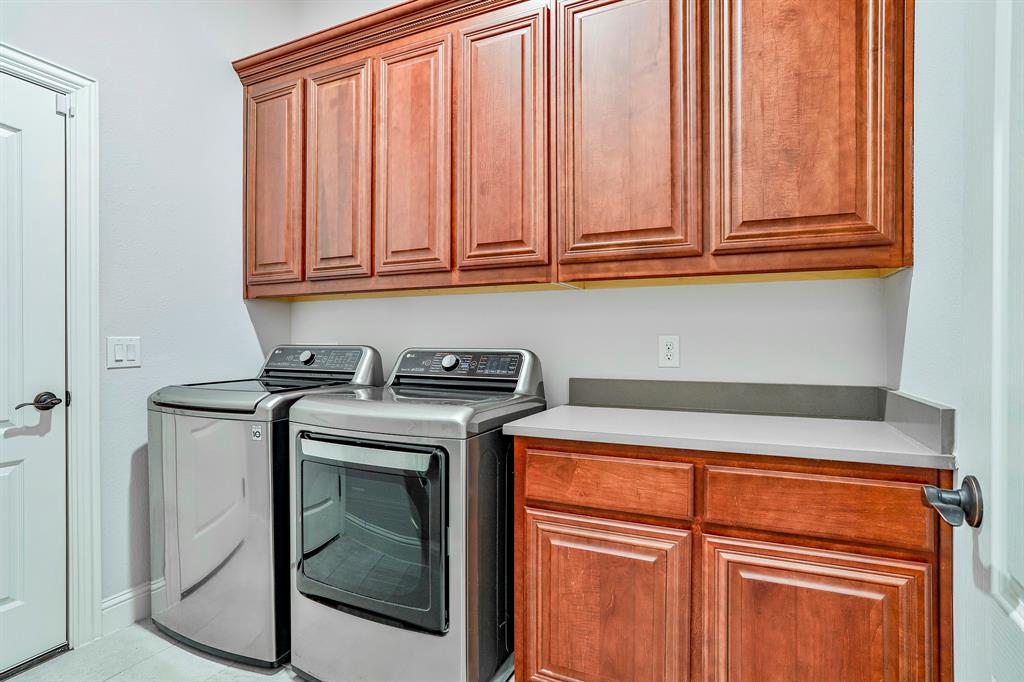 2425 Turning Leaf Lane Midlothian, TX 76065 - Photo 7 of 29 Laundry area featuring washing machine and dryer, cabinet space, and light tile patterned floors