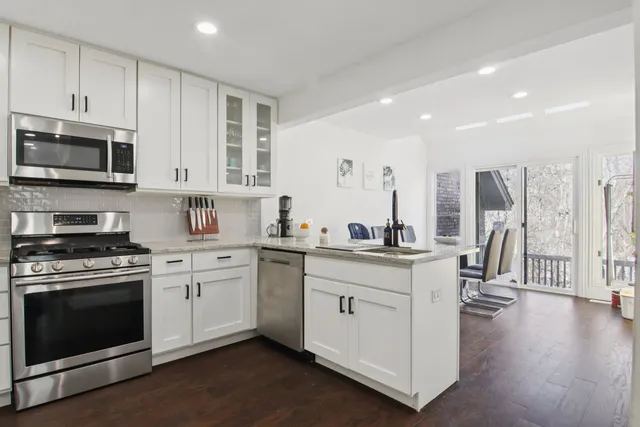 a kitchen with stainless steel appliances granite countertop a stove and a sink