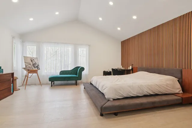 a spacious bedroom with a bed and a couch