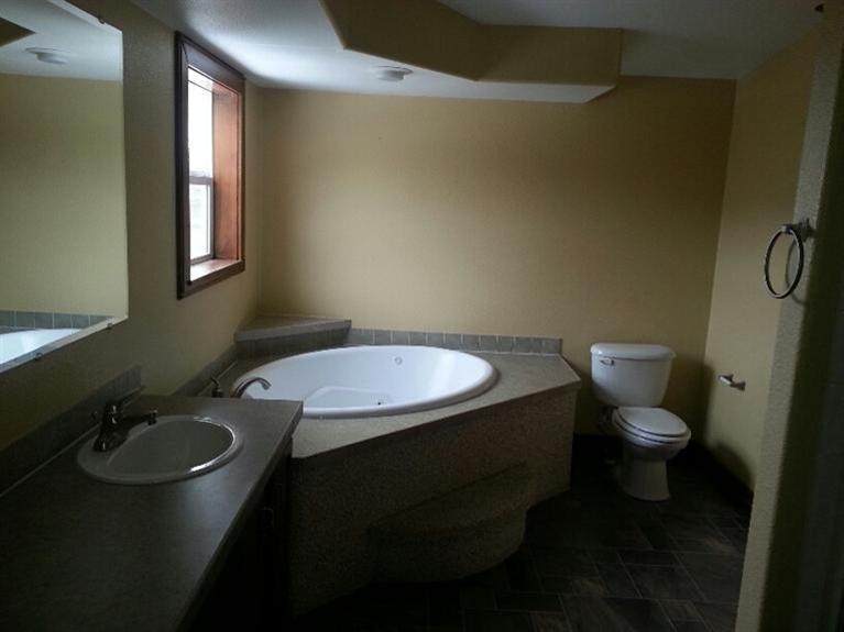 102 Cut Throat Loop Gypsum, CO 81637 - Photo 5 of 5 a bathroom with a granite countertop toilet a sink and a mirror