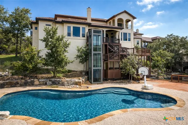 a view of a house with backyard and sitting area