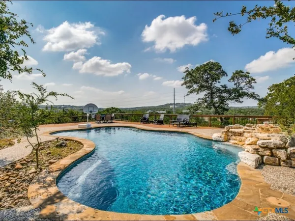 a view of a swimming pool with an outdoor seating