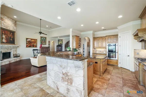 a large kitchen with a table and chairs