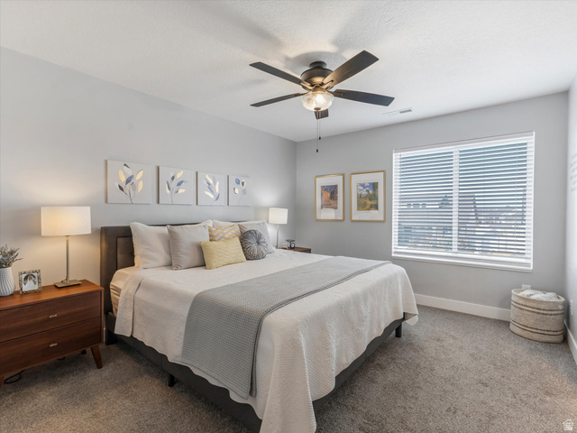 3047 Old Emigrant Road, Unit C Syracuse, UT 84075 - Photo 12 of 20 Carpeted bedroom featuring ceiling fan and baseboards