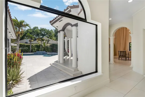 a living room with furniture a fireplace and a large window