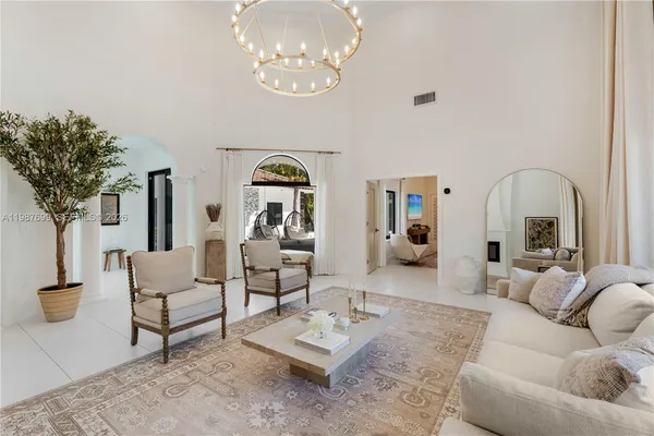 a view of living room with furniture and chandelier