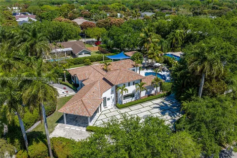 a view of a patio with a table and chairs and potted plants