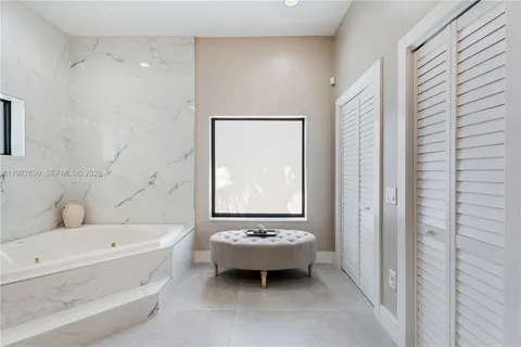 a view of a backyard with plants and outdoor seating