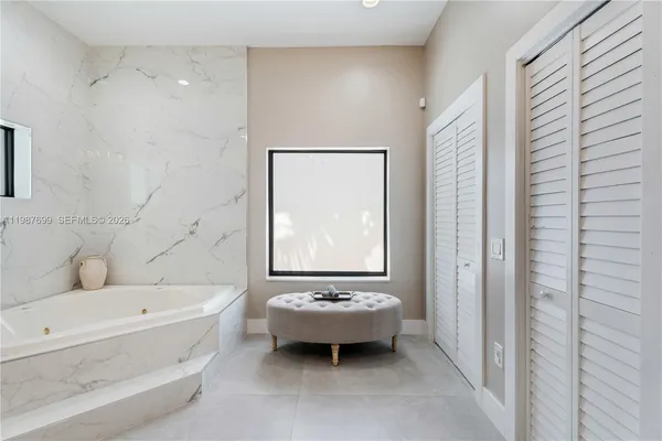 a view of a backyard with plants and outdoor seating