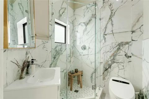 a view of a patio with a table and chairs potted plants