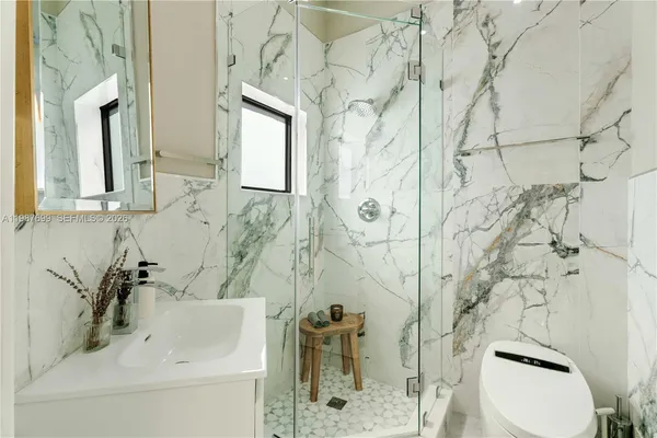 a view of a patio with a table and chairs potted plants
