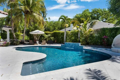 an aerial view of residential house with outdoor space and swimming pool