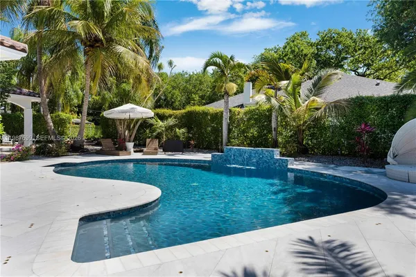 an aerial view of residential house with outdoor space and swimming pool
