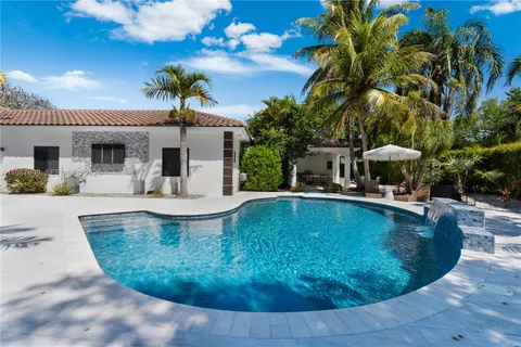 a view of backyard with swimming pool and outdoor seating