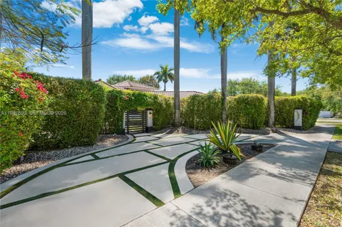 a view of a hallway with seating area and a kitchen view