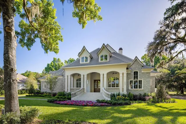 a front view of a house with a garden