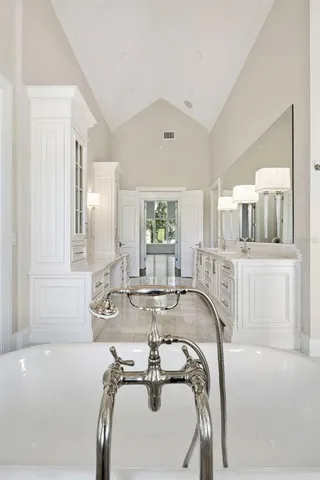 a view of a room with wooden floor and white walls
