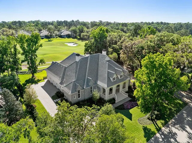 an aerial view of a house with a garden and a yard