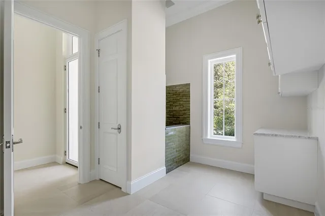 an empty room with windows and closet