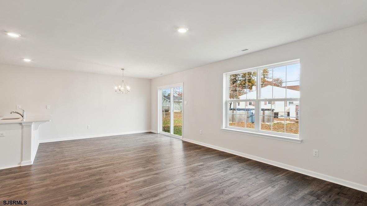 103 West Drumbed Road Villas, NJ 08251 - Photo 11 of 23 an empty room with wooden floor and windows